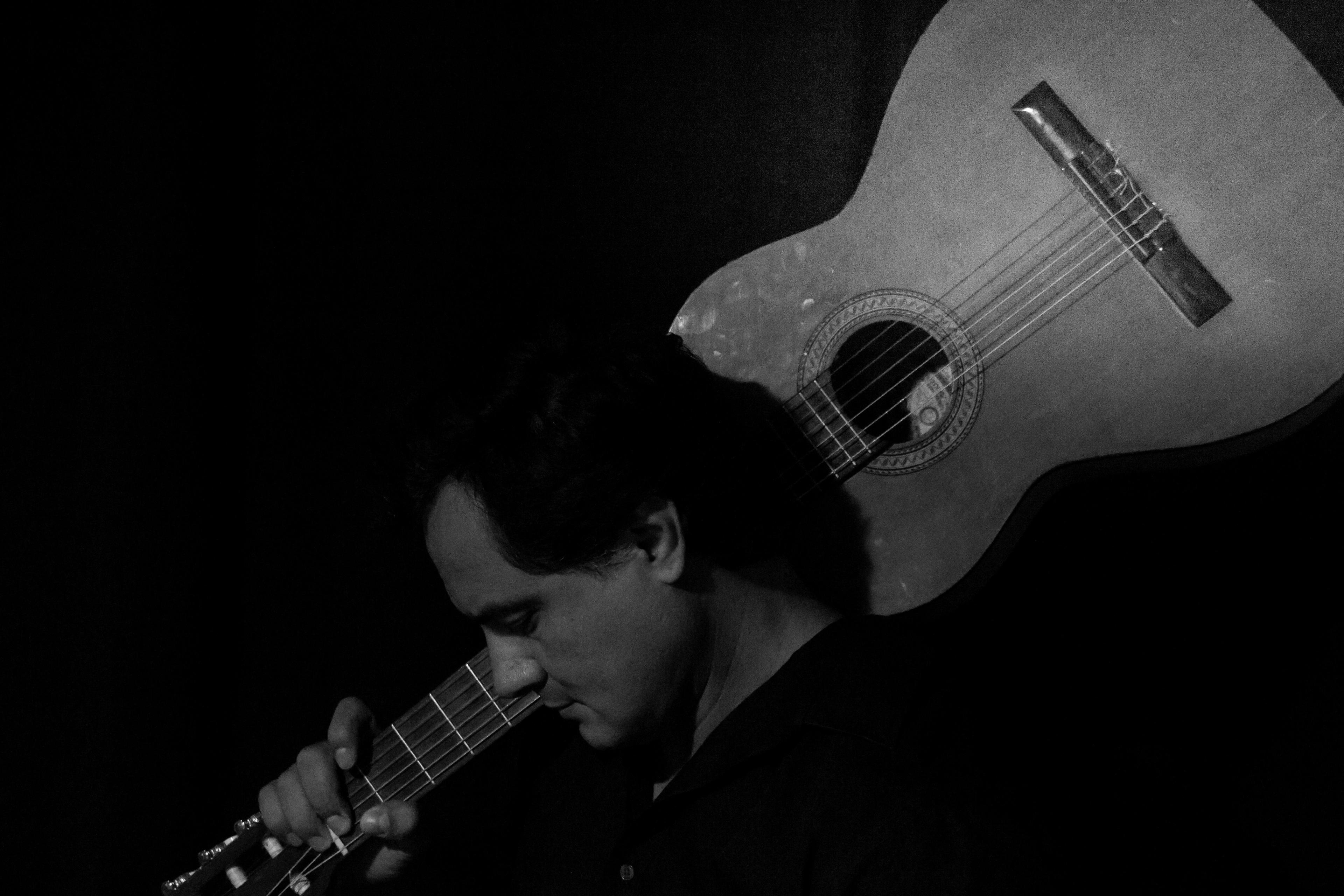 Jesús Daniel Hernández performing guitar on stage